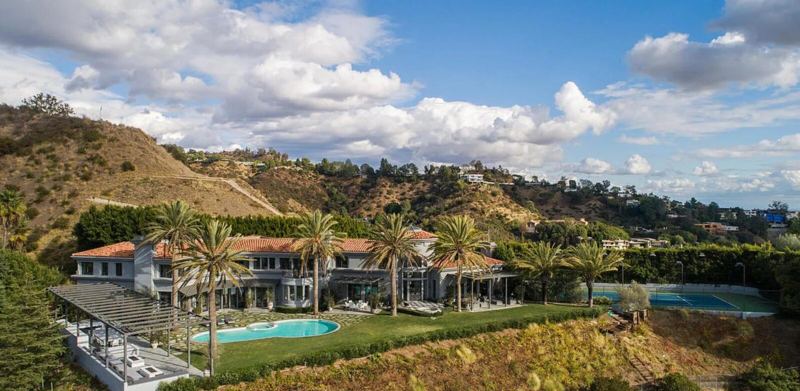 Aerial of hillside estate with pool and tennis court