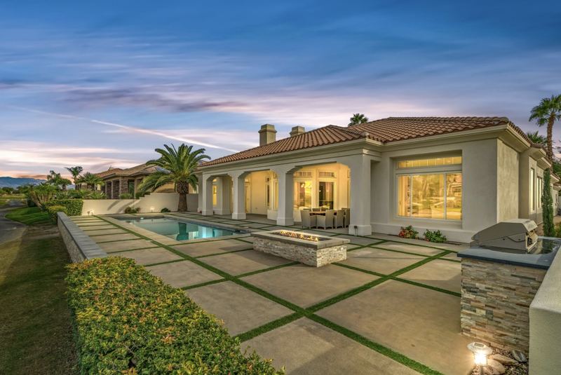 Lit pool terrace at dusk, Rancho Mirage home