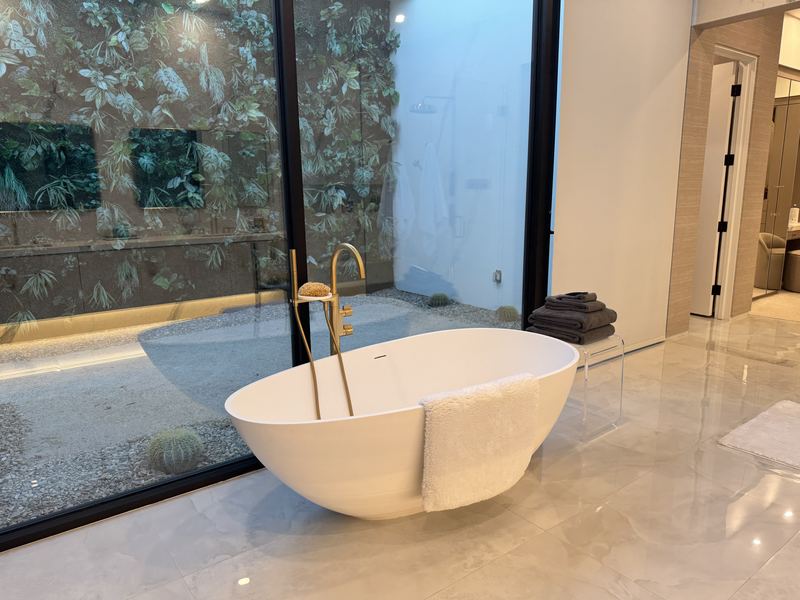 Freestanding tub facing a private garden